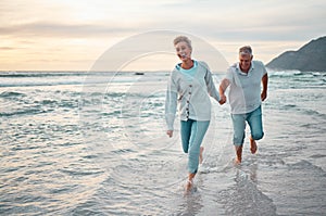 Beach, walking and senior couple holding hands for support, love and care with outdoor wellness, retirement and holiday