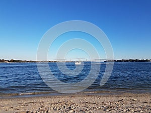 beach and water and bridge at Solomons Island Maryland with boats