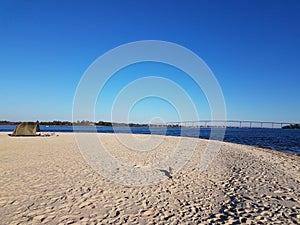 beach and water and bridge at Solomons Island Maryland with tent