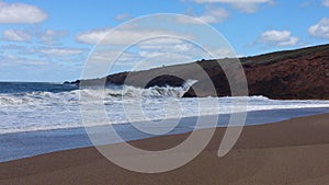 Beach and water waves in a sunny cloudly day