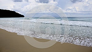 Beach and waves with gloomy sky