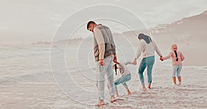 Beach, waves and parents playing children for holiday, vacation and adventure in winter. Family, travel and mother