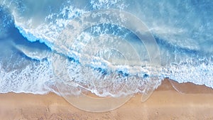 Beach and waves from top view. Summer seascape from air. Top view from drone.