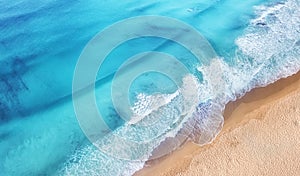 Beach and waves from top view. Turquoise water background from top view. Summer seascape from air.