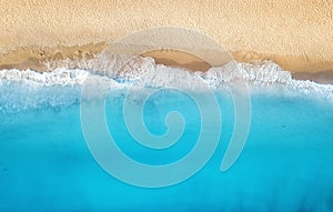 Beach and waves from top view. Turquoise water background from top view. Summer seascape from air.