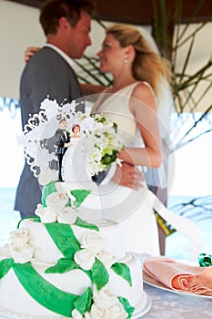 Beach Wedding Ceremony With Cake In Foreground