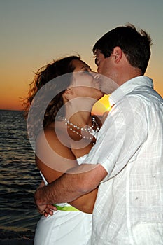 Beach wedding couple kiss