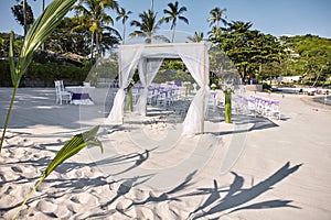 Beach wedding venue settings at seaside, shot from the backside, Arches, Altar with minimal flowers decoration
