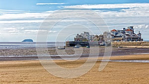 The beach at Weston-Super-Mare with boats and buildings in the background.