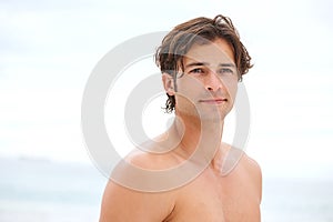 The beach is where I belong. a handsome young man enjoying a relaxing day at the beach.