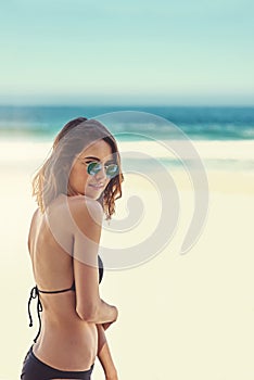 The beach is where I belong. Portrait of a beautiful young woman at the beach.