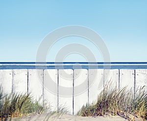 Beach and White Wooden Fence