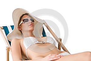 Beach - woman in bikini with hat sunbathing