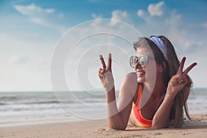 Beach woman funky happy and colorful wearing sunglasses having summer fun during travel holidays vacation. Young trendy