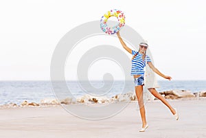 Beach woman happy and colorful wearing sunglasses and beach hat having summer fun during travel holidays