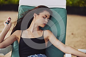 beach woman sun resort ocean sand lifestyle lying sunbed sea smiling