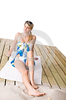 Beach - woman sunbathing with pareo and sunglasses