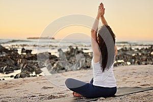 Beach, woman and yoga as exercise or workout in Los Angeles for wellness, wellbeing and health by sea. Back view, female