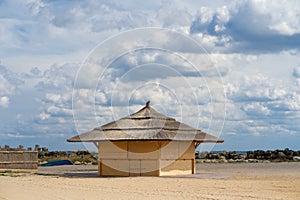 Beach wooden cabin with fluffy clouds