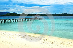 Beach and wooden dock on Bolilanga Island. Togean Islands. Indonesia.