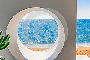 Beach at World's End Park, Sanya, China. View of a beautiful and sea through a round hole in a wall.