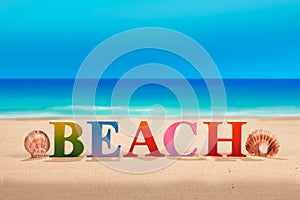 @beach written in colorful wood letters at the beach