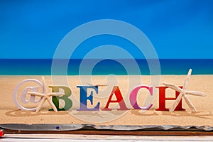 @beach written in colorful wood letters at the beach