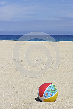 Beachball on empty sandy beach photo