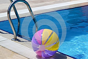Beachball and swimmingpool. Summer vacations photo