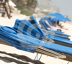 Beachchairs on the sand in Cancun, Mexico photo