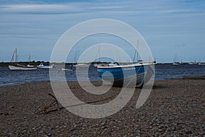 Beached blue wooden fishing tender