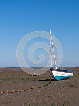 Beached boat, far from sea. Tide out, Bristol Channel tidal reach. Instow.