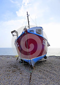 Fishing boat beached on shingle
