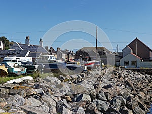 Beached Inshore Fishing Boats stacked at the Harbours edge amongst the old Fishermens Cottages of Gourdon