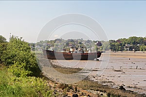 Beached wreck on a tidal riverbed