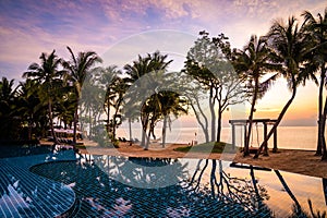 Beachfront sunrise with pool and palm trees in Hua Hin, Prachuap Khiri Khan, Thailand