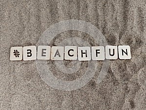 #beachfun  beach fun written on wood blocks on the sand