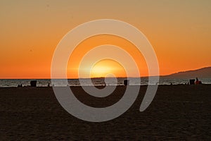 Beachgoers, families the sunset and the Santa Monica Pier