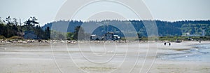 Beachgoers during low tide at Deception Pass state Park