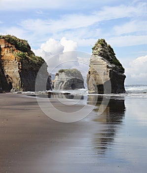 Beachscape in Tongaporutu, New Zealand featuring the majestic Three Sisters and Elephant Rock