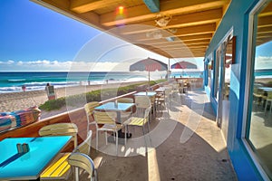 beachside eatery, with view of glistening ocean waves and sunlit skies