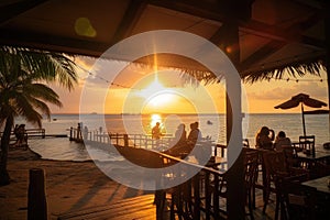 beachside eatery with view of sun setting over the water