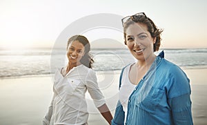 The beachside was made for long strolls. Shot of a loving couple walking hand in hand on the beach.