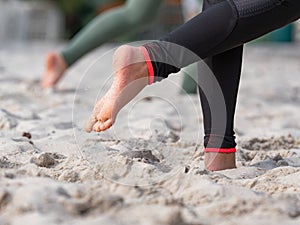 Beachvolleyball court with detail of running female feets