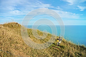 Beachy Head cliff, the highest at Seven Sister country park and graves of suicides who jumped down and blue seascape of English ch