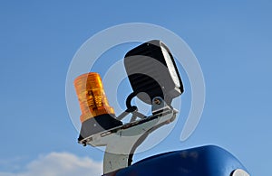 The beacon on the machine flashes orange warning color. everyone around will notice the unusually large load and avoid an accident