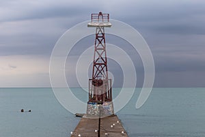 Beacon on pier of Lake Michigan during a storm