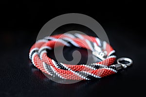 Bead crochet necklace red, black and white colors on a dark background