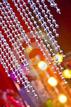 Bead curtain with cream-colored walls. Selective focus diamond bead can be used as background or texture