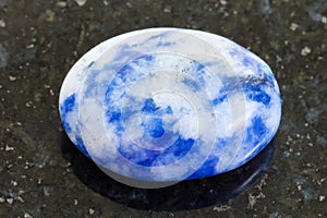 bead from Lapis lazuli gemstone on dark